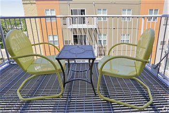 a table and two chairs on a balcony